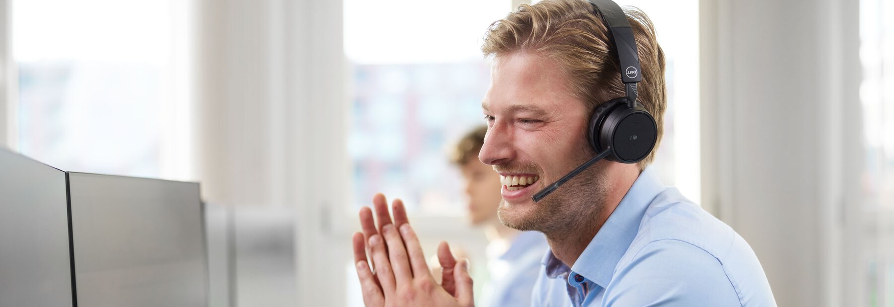 Young man with headset smiling