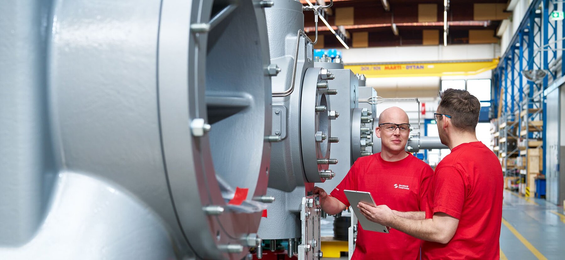 Manufacturing of process gas compressor at Burckhardt Compression site, engineers discussing