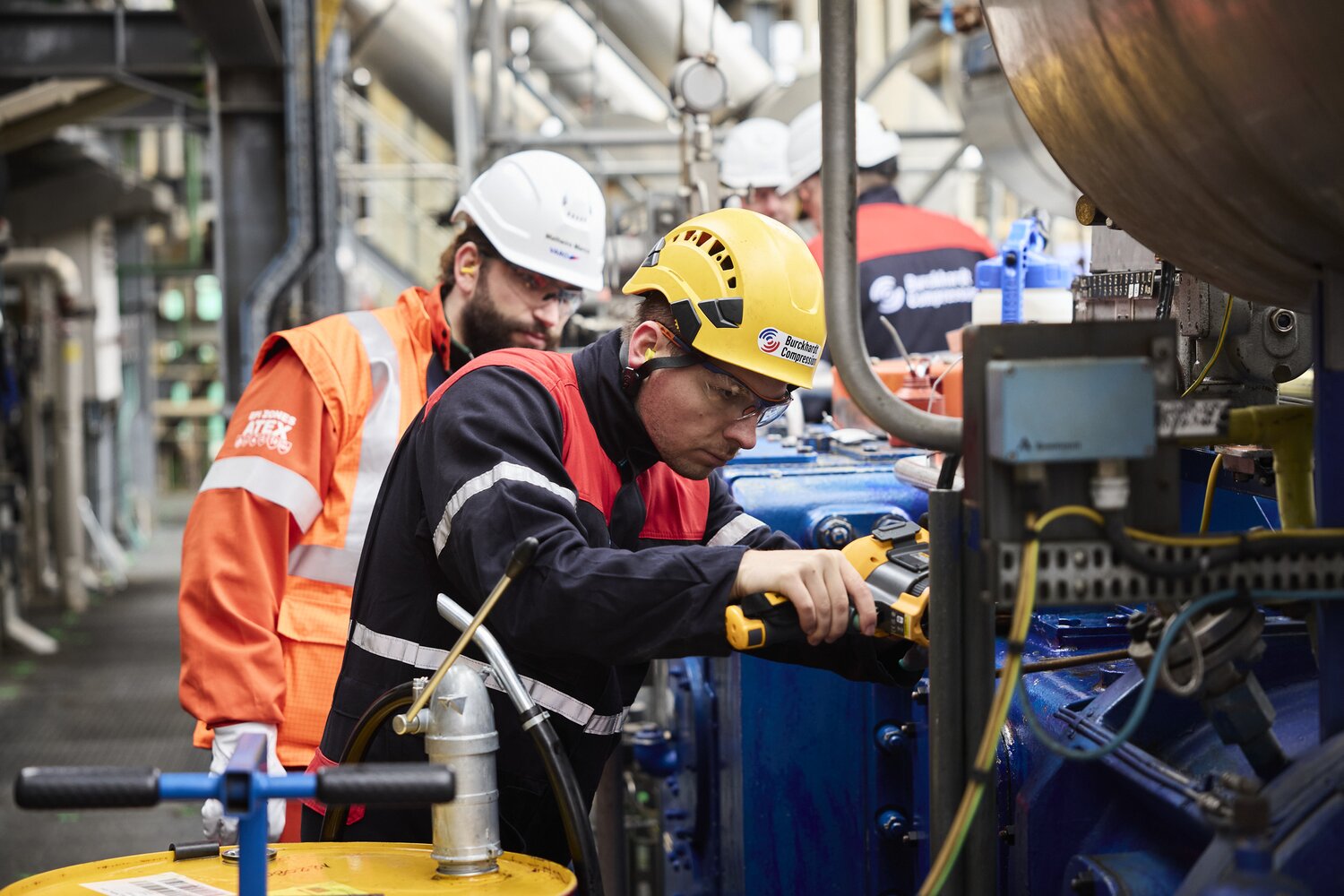 Men working at compressor on customer site