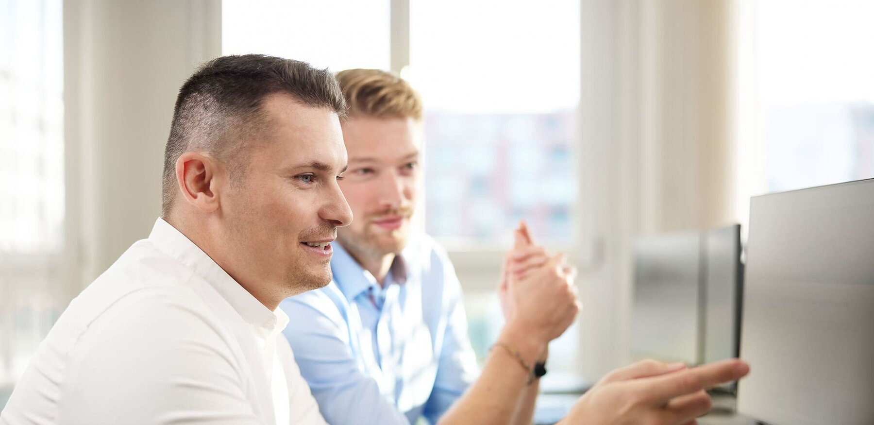 Two people at an office providing customer service remotely