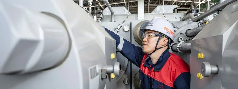 Engineer working on compressor in workshop