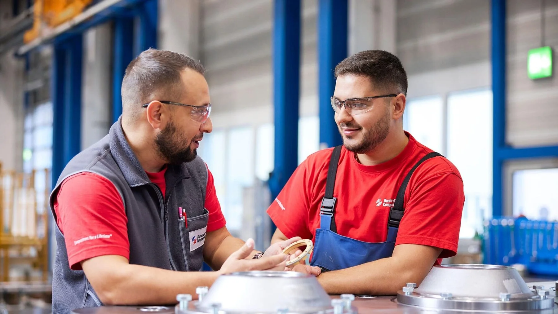 Two persons discussing about in a workshop