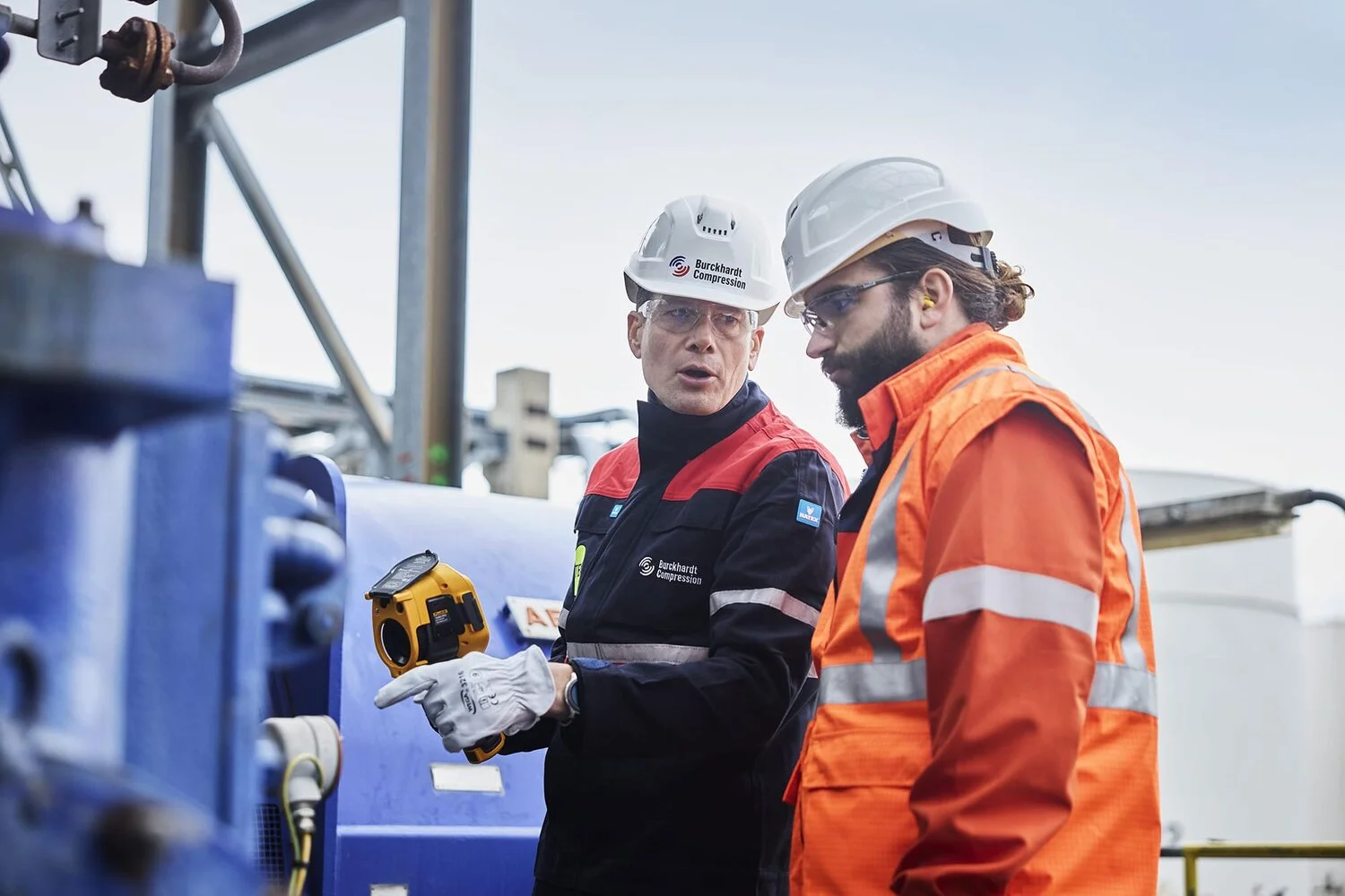 BC ACTIVATE compressor assessment to optimize compressor operation Field service engineers discussing in front of installation