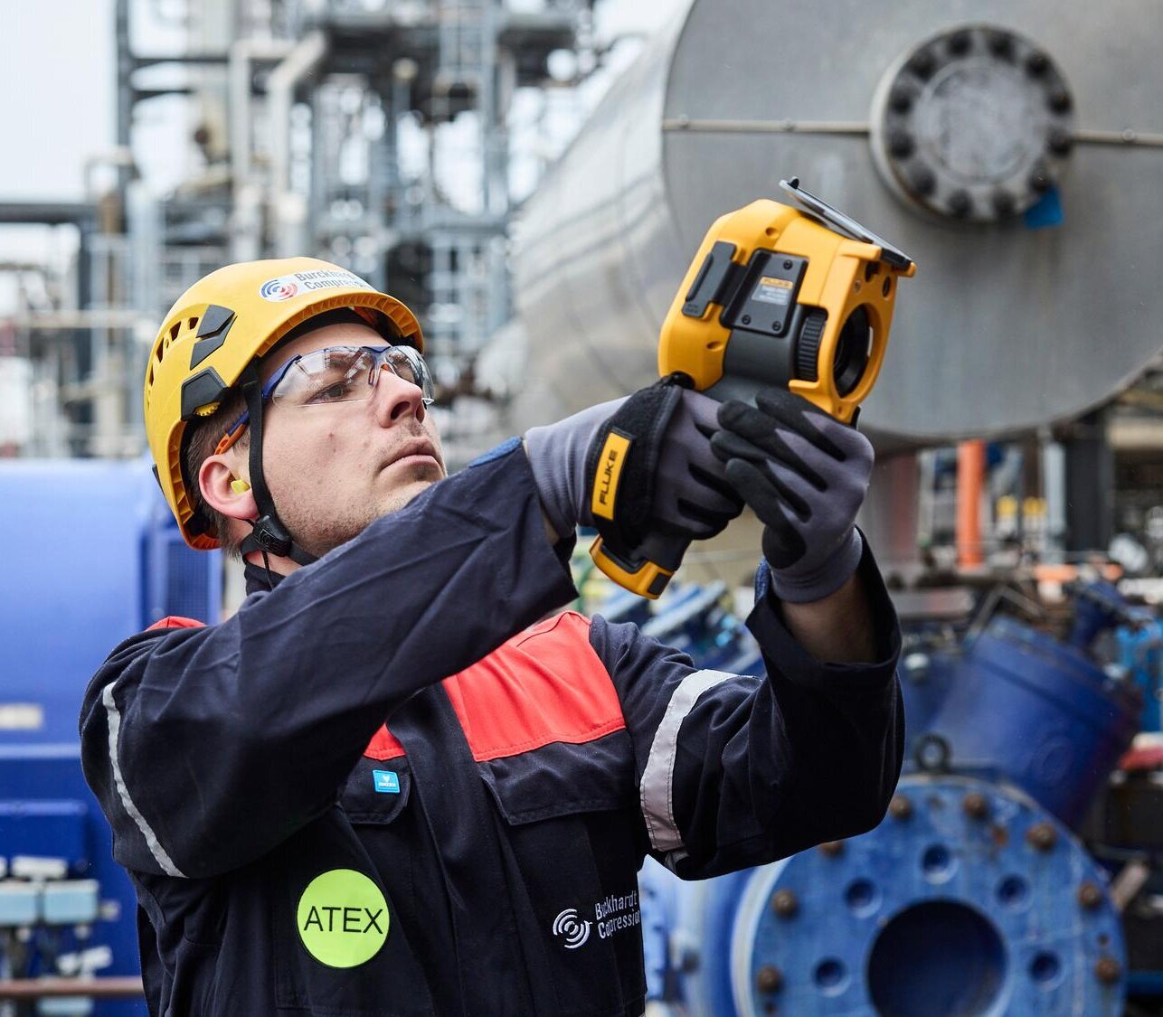 Service engineer measuring data for compressor assessment 