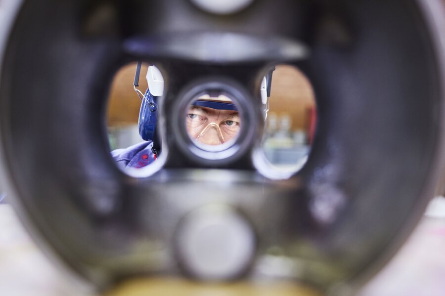 Technician looking through compressor part