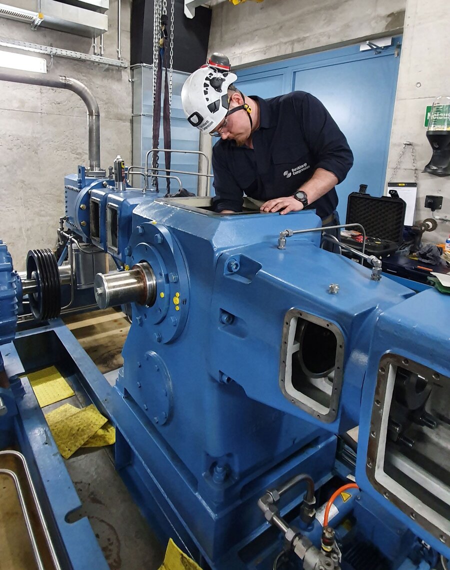 Technician working on non-Burckhardt compressor